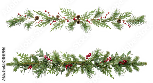 Christmas pine garlands with red berries and cones isolated on white background.