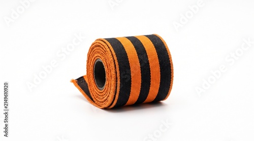 Orange and black striped ribbon roll on white background for festive decorations and crafts