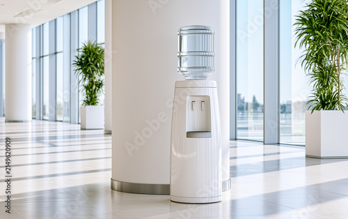 Elegant bottled water cooler standing in a spacious modern office lobby with white walls and green indoor plants, bright sunshine streaming through floor to ceiling windows
