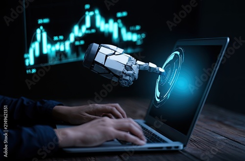 Robotic finger interacts with glowing interface on laptop screen
