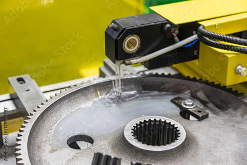 Fotografie Precision gear machining process in industrial workshop, large metallic gear bei