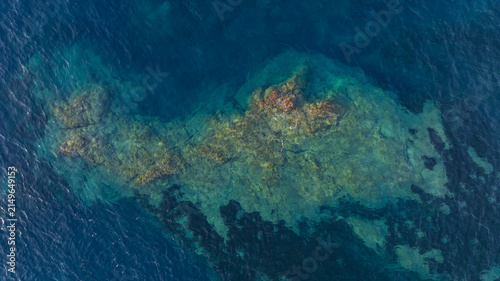 Top down aerial view of crystal clear Mediterranean waters over underwater rocks on the Esterel coast, France