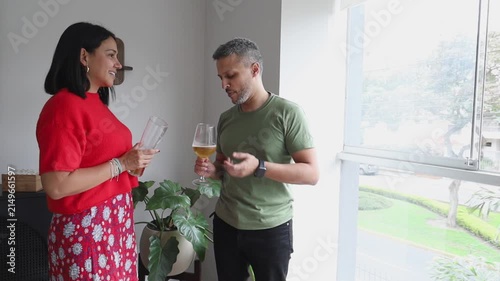 Two Adults Laughing and Joking While Drinking Together at Home