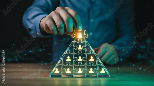 Strategic business concept with glowing puzzle pieces forming a pyramid symbolizing teamwork and success