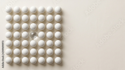 White spheres grid with one transparent glass sphere for anomaly detection
