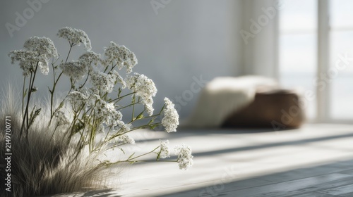 White flowers, tall grass in minimalist room with sunlight