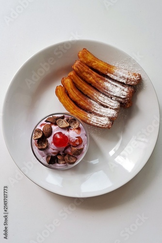 Churros, crispy and golden, dusted with sugar and cinnamon. A delicious, sweet treat often enjoyed with chocolate dipping sauce, perfect for satisfying any dessert craving.