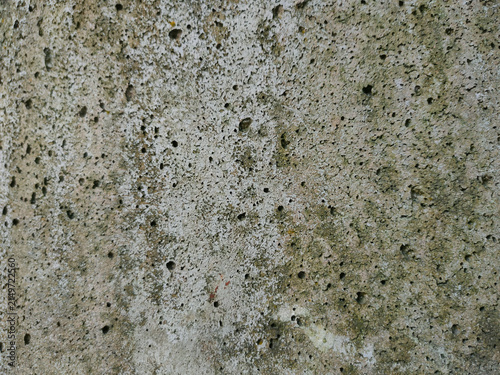 фотографія A close up view of porous concrete wall showing numerous tiny holes and a pitted