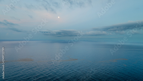 Bild auf Leinwand Aerial view of full moon rising over the sea in Playa del Carmen at twilight