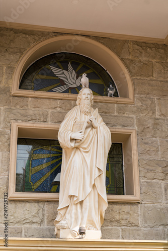Obraz na plátně Statue of Jesus Christ with stained glass background in church