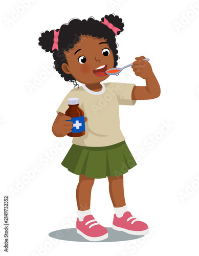 Sick African girl taking medicine syrup from a spoon