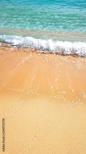 Pristine Tropical Beach Shoreline with Crystal Clear Turquoise Water Gentle Foam Waves and Golden Sunlit Sand for Summer Vacation Background