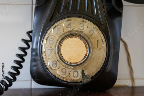 Foto Antique black rotary dial telephone close-up showing numbers and coiled cord aga
