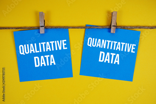 Qualitative Data Vs Quantitative Data paper notes hanging on the rope with clothespins