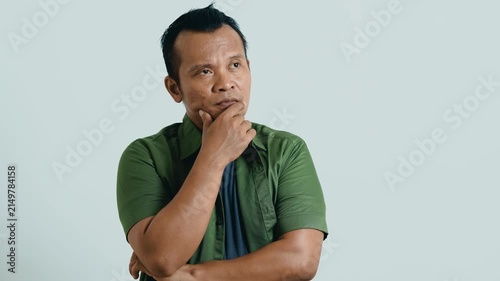 Portrait of pensive inspired hesitate Asian man thinking idea creative, think dreaming and doubtful unsure considering solution decide, thoughtful contemplating for ads.
