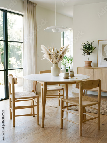 Modern kitchen dining table with flowers and natural light