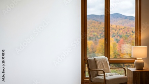 Interior - Cozy armchair and lamp near window with autumn mountain view