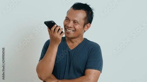 Phone call. Portrait of man talking on smartphone or using virtual personal assistant app on his device. Asian man recording audio call with mobile phone.