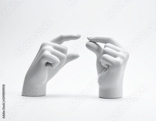 Gray hands forming pointed finger gesture against white background, minimalist abstract hand art