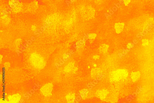 Abstract orange and yellow painted texture with bright mottled areas and expressive color variations, creating a warm energetic background for creative designs, posters, packaging and digital artwork.