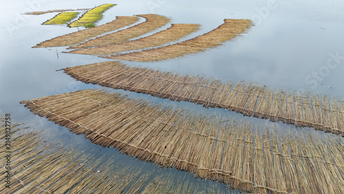 Jute bundles float on Bortir Bil in rural India, reflecting traditional livelihoods and sustainable agriculture. Jute, a natural biodegradable fiber, offers an eco-friendly alternative to plastic. 