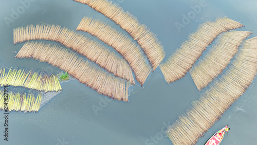 Jute bundles float on Bortir Bil in rural India, reflecting traditional livelihoods and sustainable agriculture. Jute, a natural biodegradable fiber, offers an eco-friendly alternative to plastic. 