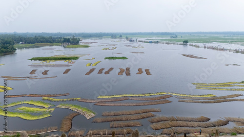 Jute bundles float on Bortir Bil in rural India, reflecting traditional livelihoods and sustainable agriculture. Jute, a natural biodegradable fiber, offers an eco-friendly alternative to plastic. 