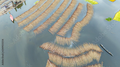 Jute bundles float on Bortir Bil in rural India, reflecting traditional livelihoods and sustainable agriculture. Jute, a natural biodegradable fiber, offers an eco-friendly alternative to plastic. 