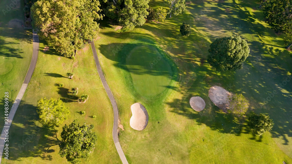 Fototapeta premium Aerial View of a Lush Green Golf Course with Sand Bunkers
