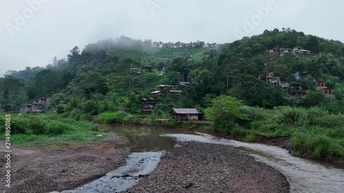 Aerial video showing mountains and morning mist in a rural village in Nan Province, northern Thailand.
