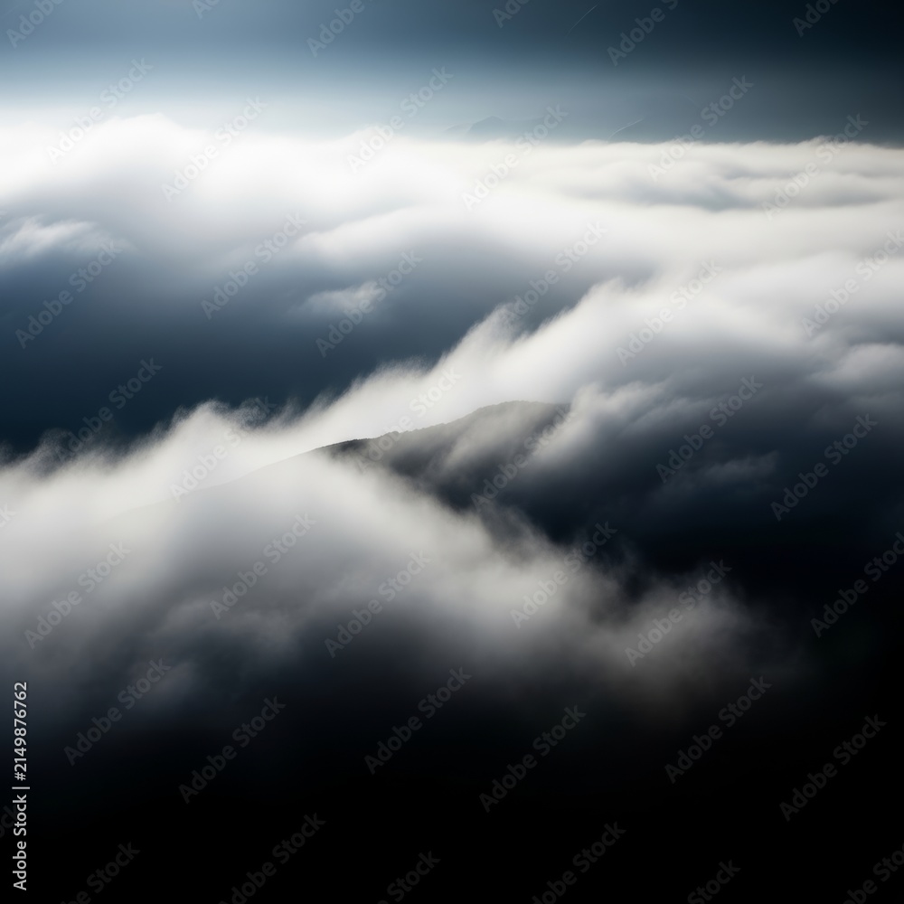 Obraz premium Thick billows of rolling white fog swirl through a dark landscape, creating a textured grainy effect with soft lighting and deep shadows, depth, soft, swirls