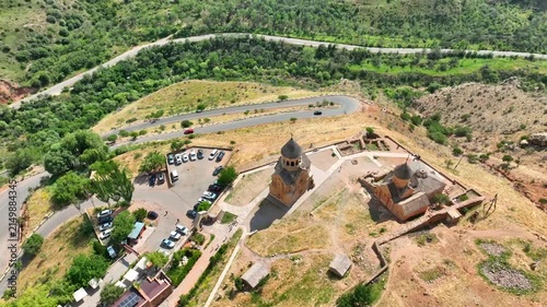 Bird's-eye shot of Noravank monastery perched on hilly landscape