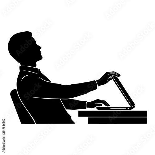 Man working on laptop computer at desk in profile view.
