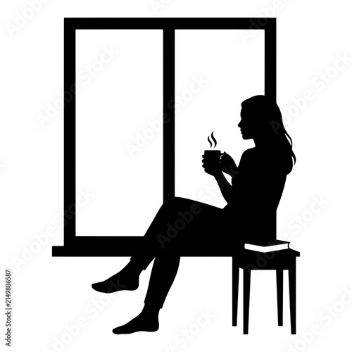 Woman drinking hot beverage by window with book on stool.