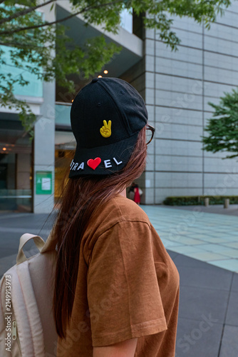 A traveler girl with a suitcase in the city