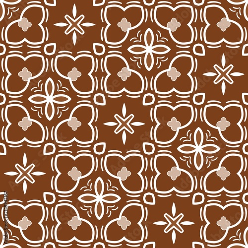 Brown and white geometric pattern with repeating floral motifs. Each tile features stylized, symmetrical flower and star shapes. Design creates a seamless, elegant, traditional tile look