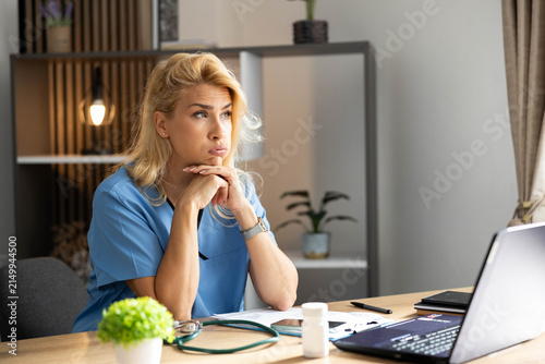Healthcare worker feeling tired and overwhelmed, suffering from stress and depression in a medical office environment