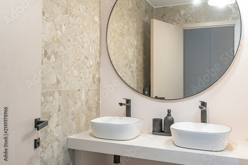 Modern white bathroom interior with bathtub, skylight and minimalist vanity