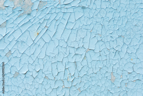 Textured blue background with cracked paint suitable for various uses in design and artwork