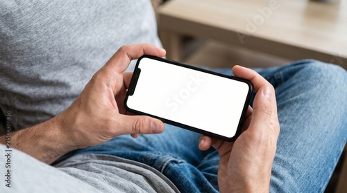 Person holding a smartphone with a blank screen