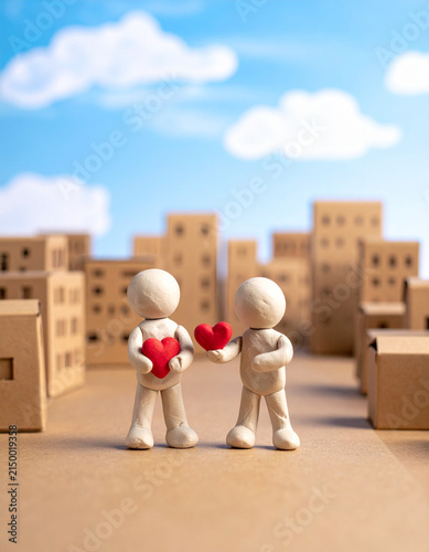 Two Clay Figures Exchanging Red Hearts Online Dating Concept