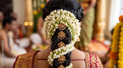 Close-up of fresh jasmine flowers woven into Indian bride's hair
