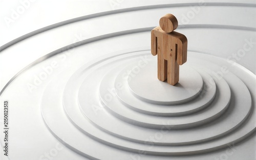 Wooden figure stands atop concentric circles, symbolizing focus or journey.