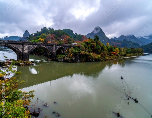 Scenic riverside village with traditional houses and boats.