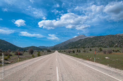 A road in the mountains under a blue sky.