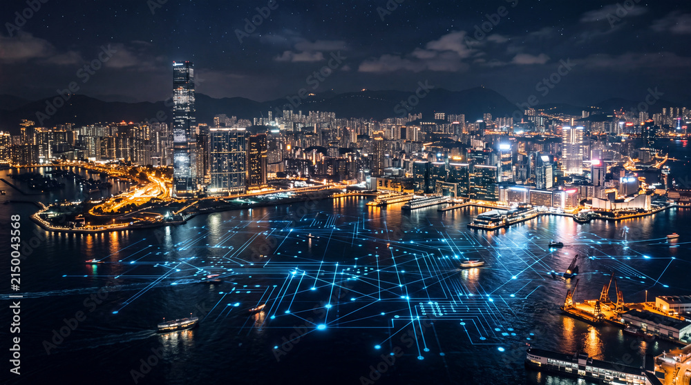 Obraz premium A vibrant city skyline at night with illuminated skyscrapers and a waterfront filled with glowing lights and digital overlays