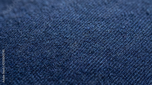 Close-up of indigo woven fabric displaying intricate textures and rich blue tones with a soft sheen