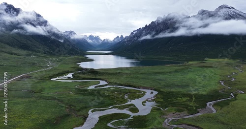 	
Beautiful green grassland and lake under cloudy sky 
