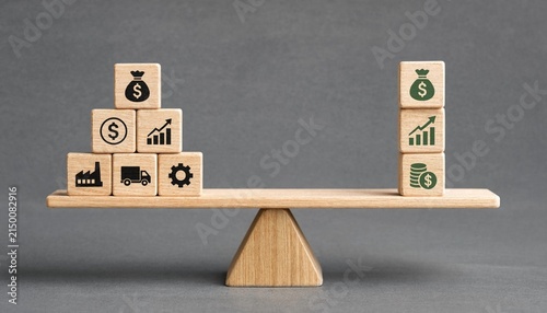 Balanced wooden blocks symbolizing financial growth investment and business stability on a seesaw