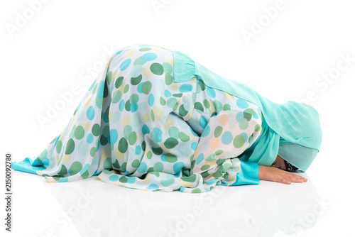 Side view horizontal portrait of cute young Asian Muslim girl performing Sujud prostration isolated on white background.